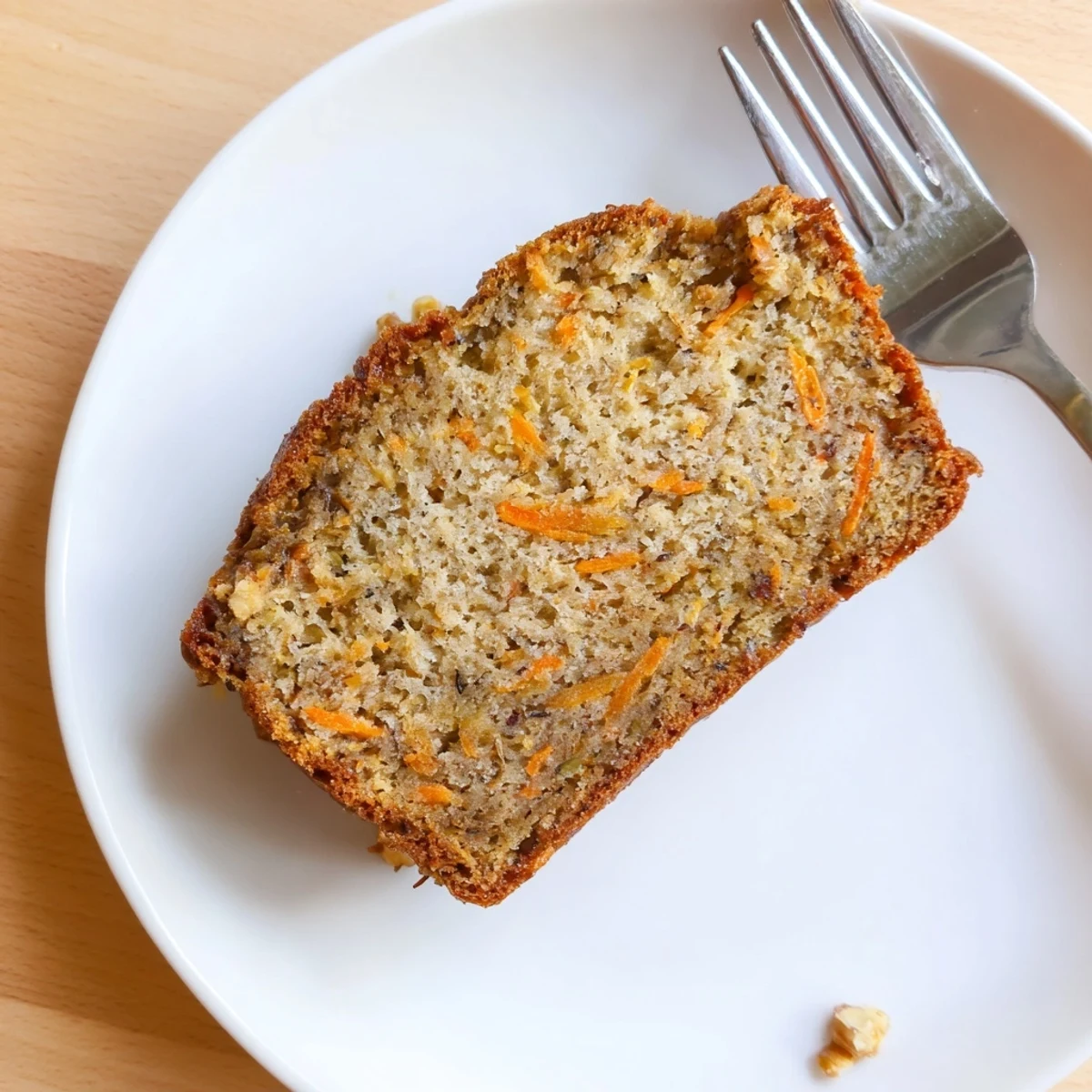 Moist carrot cake banana bread warm from the oven with walnuts and grated flecks throughout, served with a cup of coffee