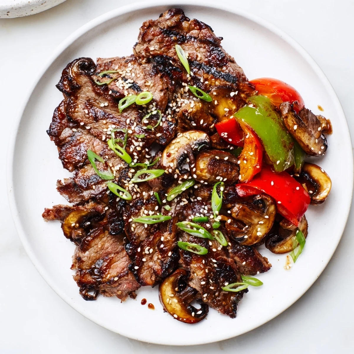 Tender Beef Yakiniku served over steamed white rice with charred bell peppers