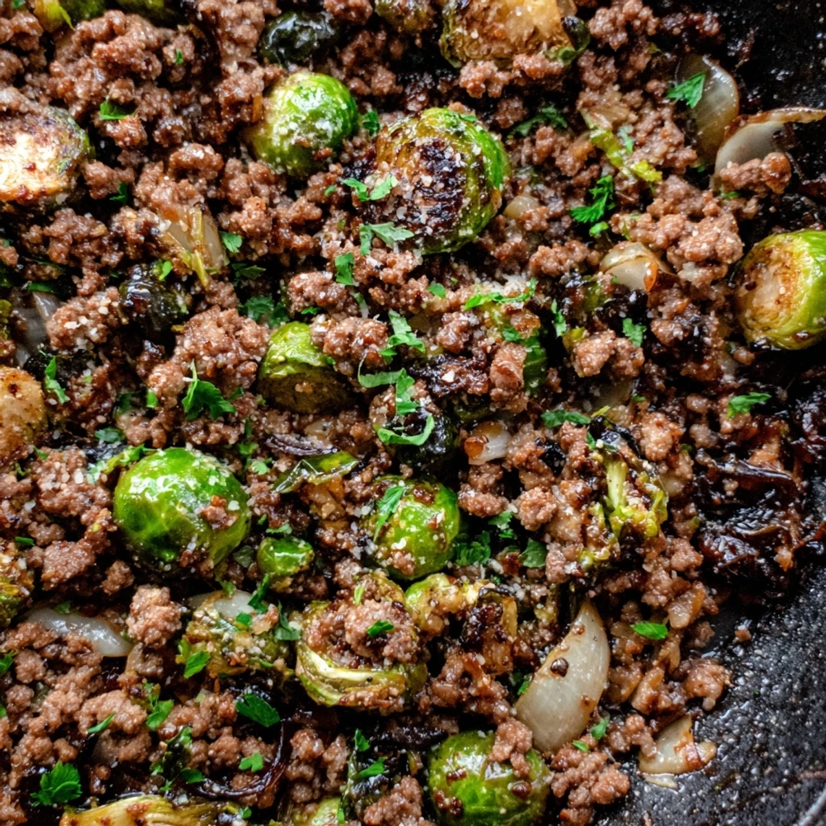 Golden brown Ground Beef Brussels Sprouts skillet sizzling with caramelized edges and savory seasonings