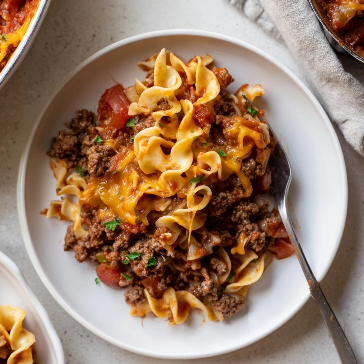 Slice of Beef Noodle Casserole on plate, creamy noodles and tomato aroma