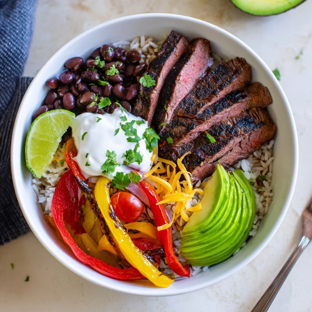 Steak Fajita Power Bowls with sizzling marinated steak, colorful peppers, creamy avocado.