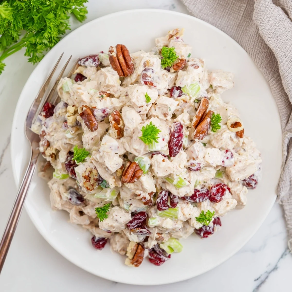 Close-up of cranberry pecan chicken salad showcasing tender chicken chunks, bright red cranberries, and crunchy chopped pecans