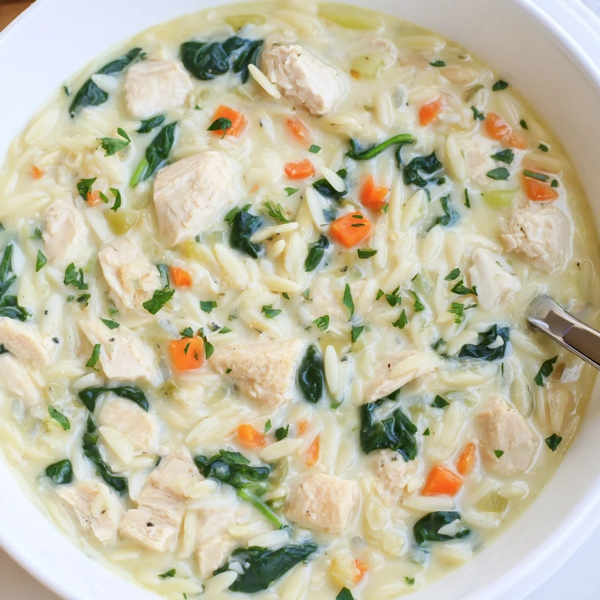 Creamy Chicken Florentine Soup With Orzo ladled over crusty bread, rich aroma.
